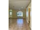 Spacious living room featuring tile floors and large windows at 10448 Canary Ave, Weeki Wachee, FL 34613