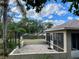 Back patio with screened enclosure and adjacent yard at 10448 Canary Ave, Weeki Wachee, FL 34613