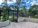 Backyard patio with pergola and lush landscaping at 10448 Canary Ave, Weeki Wachee, FL 34613