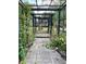 Brick pathway leads through a pergola covered in vines at 10448 Canary Ave, Weeki Wachee, FL 34613