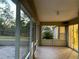 Screened porch with tile flooring and access to backyard at 10448 Canary Ave, Weeki Wachee, FL 34613