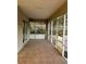 Large screened porch with tiled floor and access to the backyard at 10448 Canary Ave, Weeki Wachee, FL 34613