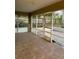 Bright screened porch with tiled floors and backyard access at 10448 Canary Ave, Weeki Wachee, FL 34613