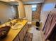Functional bathroom with double sinks, tile flooring, and a shower-tub combo at 12266 Birch St, Brooksville, FL 34613