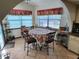 Charming breakfast nook with tiled flooring, large windows and quaint breakfast table at 12266 Birch St, Brooksville, FL 34613