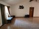 Living room featuring tile floors, neutral walls, and natural light through a window at 12266 Birch St, Brooksville, FL 34613