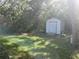 Backyard shed offers practical storage solutions in a serene, wooded setting at 12266 Birch St, Brooksville, FL 34613