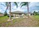 Landscaped backyard with decorative features and fencing at 13600 Crest Lake Dr, Hudson, FL 34669