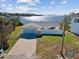 Aerial view of a waterfront home with a driveway and fenced yard at 1904 Gulfview Dr, Holiday, FL 34691
