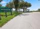 Entrance to Anclote Gulf Park, featuring a sign and paved path at 1904 Gulfview Dr, Holiday, FL 34691