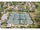 Six well-maintained tennis courts with shade structures at 2467 Crystal Lake Dr, Spring Hill, FL 34606