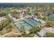 Aerial view of tennis courts, landscaping and community at 2467 Crystal Lake Dr, Spring Hill, FL 34606