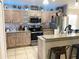 Modern kitchen with stainless steel appliances and light wood cabinets at 2510 Big Pine Dr, Holiday, FL 34691
