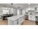 Open concept kitchen with white cabinets and an island at 3452 Umber Rd, Holiday, FL 34691