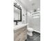 Modern bathroom with a walk-in shower, updated vanity, and elegant tile at 3452 Umber Rd, Holiday, FL 34691