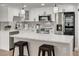 Modern kitchen with white cabinets, quartz countertops, and island at 3452 Umber Rd, Holiday, FL 34691