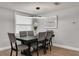 Dining room featuring a large window and modern light fixture at 3452 Umber Rd, Holiday, FL 34691
