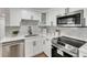 White shaker cabinets, quartz countertops, and stainless steel appliances at 3452 Umber Rd, Holiday, FL 34691