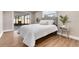 Cozy bedroom with a gray upholstered headboard and white bedding at 3452 Umber Rd, Holiday, FL 34691