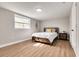 Charming bedroom featuring a full-size bed and wood-look flooring at 3452 Umber Rd, Holiday, FL 34691
