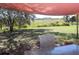 The property features an outdoor shade structure in the backyard with a table and chairs at 8700 Ross Ln, New Port Richey, FL 34654