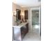 Bathroom featuring a vanity with a sink, decorative lighting, and tiled floors at 8700 Ross Ln, New Port Richey, FL 34654