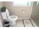 Bathroom featuring a toilet and tiled shower, a modern design, and a neutral palette at 8700 Ross Ln, New Port Richey, FL 34654