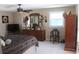 Comfortable bedroom featuring a dresser, ceiling fan, and ample natural light from a window at 8700 Ross Ln, New Port Richey, FL 34654