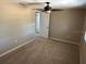 Bedroom featuring a ceiling fan and a door to an adjacent room at 8700 Ross Ln, New Port Richey, FL 34654