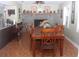 Warm dining room featuring stone fireplace, a large wooden table, and tile floors at 8700 Ross Ln, New Port Richey, FL 34654