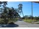 Long driveway leading to a home with a fenced yard at 8700 Ross Ln, New Port Richey, FL 34654