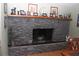 Stone fireplace creates a cozy focal point in the room at 8700 Ross Ln, New Port Richey, FL 34654