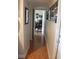 Long hallway with light tile flooring at 8700 Ross Ln, New Port Richey, FL 34654
