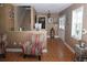 Cozy interior living room featuring staircase, tile floors, chairs and a well-lit space at 8700 Ross Ln, New Port Richey, FL 34654
