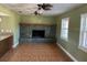 Living room with decorative fireplace, windows for natural light, and open to the kitchen area at 8700 Ross Ln, New Port Richey, FL 34654
