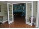 Open living room with double doors and tile floors at 8700 Ross Ln, New Port Richey, FL 34654