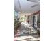 Spacious screened-in porch with seating and ceiling fan at 8700 Ross Ln, New Port Richey, FL 34654