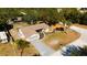 Aerial view of single-Gathering home with landscaped yard and driveway at 9053 Nakoma Way, Weeki Wachee, FL 34613