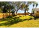 Spacious backyard with lush grass and trees at 9053 Nakoma Way, Weeki Wachee, FL 34613