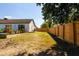 Backyard view with wooden fence and landscaping at 9053 Nakoma Way, Weeki Wachee, FL 34613