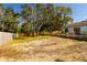 Large backyard with wooden fence and mature trees at 9053 Nakoma Way, Weeki Wachee, FL 34613