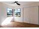 Bright bedroom featuring hardwood floors and large windows at 9053 Nakoma Way, Weeki Wachee, FL 34613