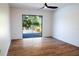 Bedroom with hardwood floors and sliding glass doors leading to patio at 9053 Nakoma Way, Weeki Wachee, FL 34613