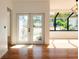 Bright entryway with hardwood floors and French doors leading outside at 9053 Nakoma Way, Weeki Wachee, FL 34613