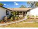 Landscaped front yard with walkway and sunroom at 9053 Nakoma Way, Weeki Wachee, FL 34613