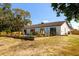 Back of house with pool and landscaped area at 9053 Nakoma Way, Weeki Wachee, FL 34613