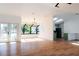 Open concept living area with hardwood floors and sunlit windows at 9053 Nakoma Way, Weeki Wachee, FL 34613