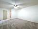 Spacious carpeted bedroom featuring a ceiling fan at 11015 Rollingwood Dr, Port Richey, FL 34668