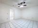 Bedroom with tile flooring and a ceiling fan at 11015 Rollingwood Dr, Port Richey, FL 34668