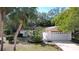 White single story home with a white garage door at 11015 Rollingwood Dr, Port Richey, FL 34668